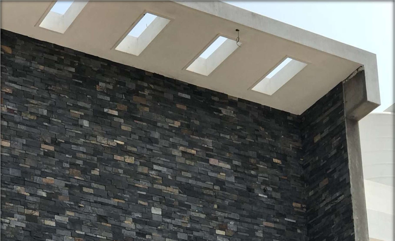 Carban Black Stone installed, 6x24" Slate cladding